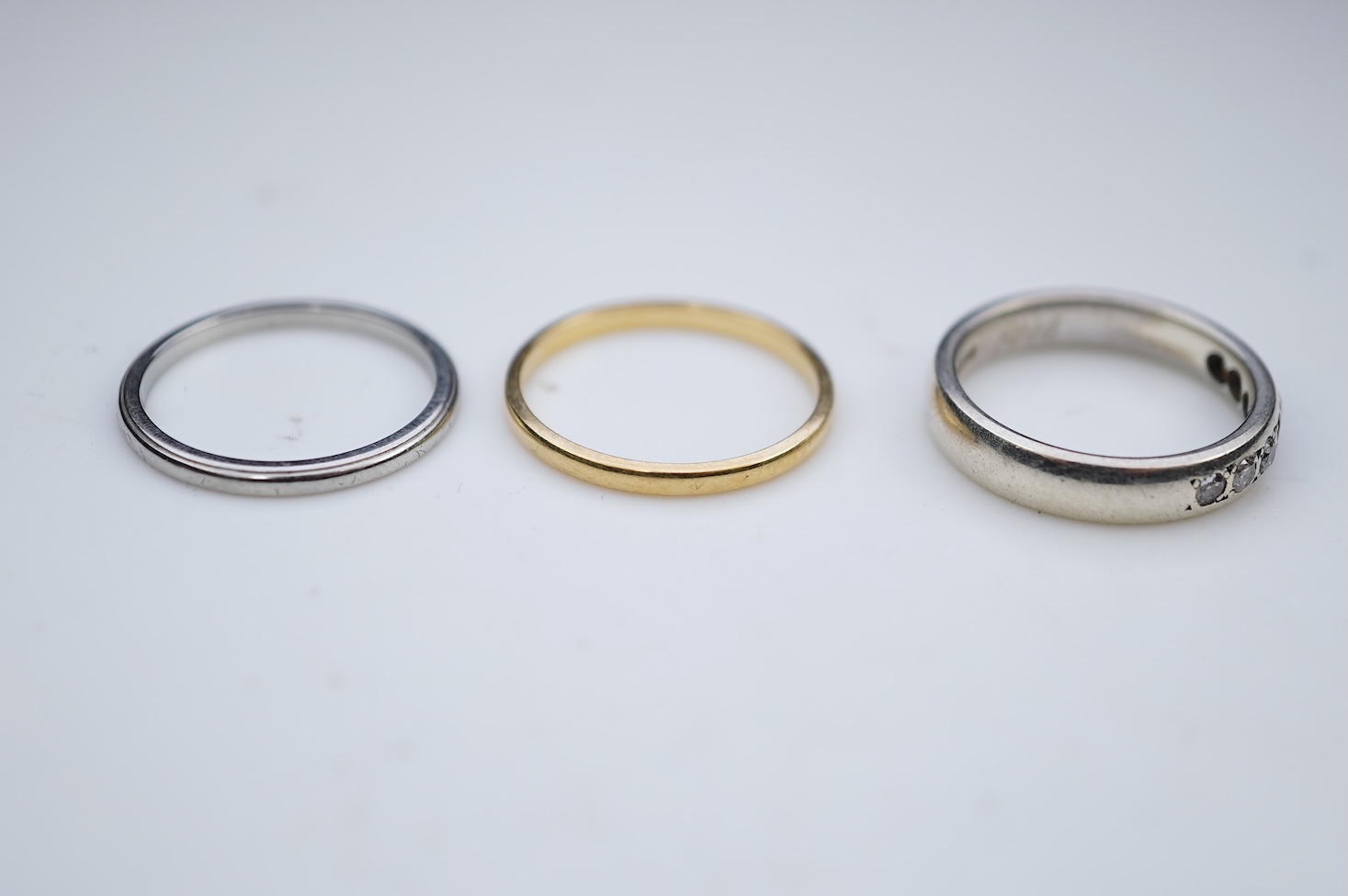 A diamond ring and two gold wedding rings
